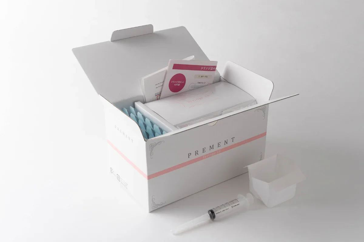 At-home insemination kit with syringe and packaging, made in Japan, on white background